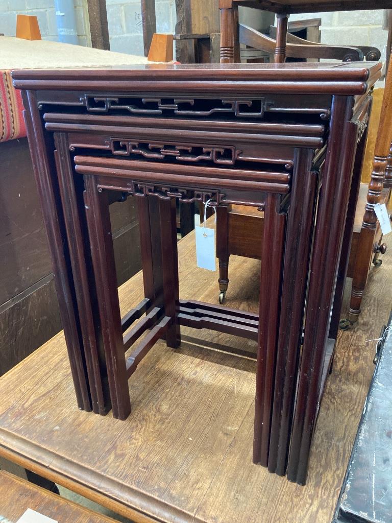 A nest of three Chinese rectangular hardwood tea tables, width 52cm, depth 36cm, height 68cm